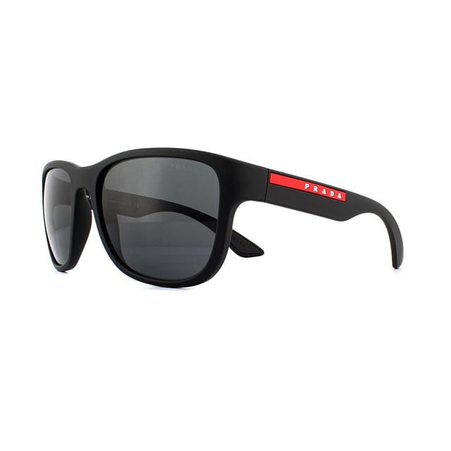 Prada Sport Sunglasses PS01US DG05S0 Black Rubber Grey are an easy to wear rectangular style. The bold style features thick temples with the red Prada Sport logo. A rubberised finish gives a sporty feel and the rubber inserts on the insides of the temples help to hold the sunglasses in place..