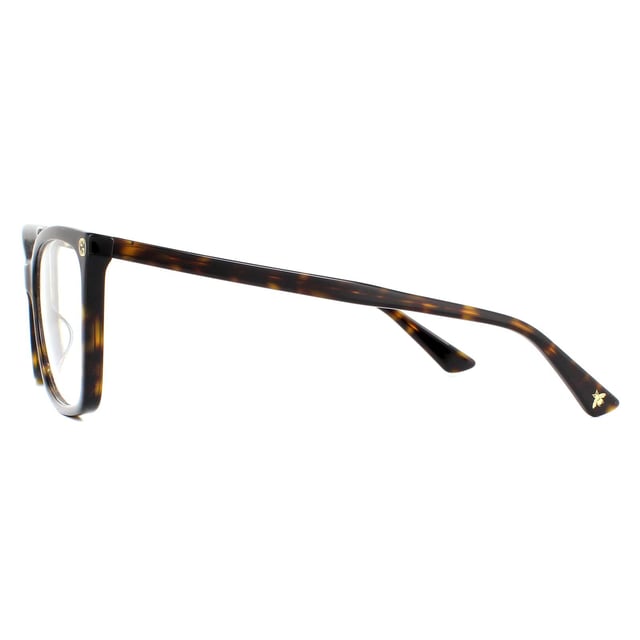 Gucci Glasses Frames GG0025O 002 Dark Havana Women are a gorgeous cat eye style crafted from lightweight acetate and features the interlocking Gucci GG logo on the frame corners, and the bee logo on one temple tip.