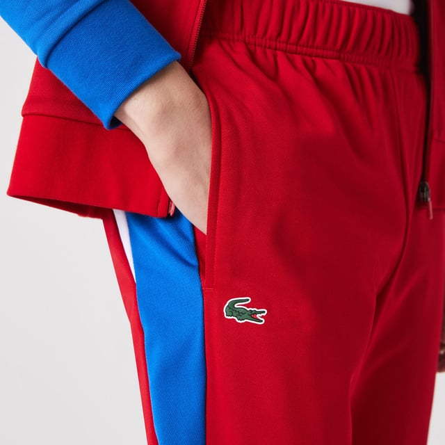 Men's Lacoste SPORT Run-Resistant Tennis Trackpants.- Regular fit, natural ease: The perfect fit for workouts.- Drawstring waist: Customised comfort and fit.- Contrast print on side: The iconic Lacoste colour-block.- Rigid crocodile sewn onto front: Quintessentially Lacoste.- Recycled polyester run-resistant piqué: Lightweight. Environmentally friendly. Material: 100% Polyester. Ref: XH9427W50.