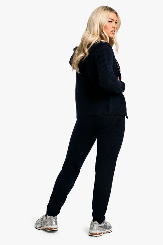 Soft Fine Guage Zip Through Hoody Knitted Tracksuit Soft fine knit fabric for ultimate comfort
Hooded top with full-length zip closure
Coordinating trousers for a complete look
Versatile two-piece set for effortless styling
Relaxed fit perfect for lounging or casual outings
Embrace laid-back chic with this soft fine knit tracksuit. The hooded top with a full-length zip offers both style and practicality, while the coordinating trousers complete the ensemble. Perfect for those lazy Sundays or running errands, this set radiates comfort without compromising on trend. Style it with trendy trainers and a baseball cap for a street-smart look, or throw on some statement jewellery to dress it up for a casual coffee date. The versatility of this co-ord allows for endless styling possibilities - layer with a puffer jacket for cooler days or wear the pieces separately to mix and match with your existing wardrobe. Whether you're heading to the gym, meeting friends for a casual brunch, or simply lounging at home, this tracksuit is your go-to for effortless, comfortable style.