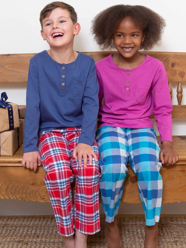 We're delighted to share these very special organic cotton pyjamas that will help your little one snooze in comfort and style. Offering the softest, single jersey grandad style top with coconut button details in this season's orchid pink, and Kite's super-soft tonal blue and cream brushed check trousers for next-to-skin comfort and kindness.