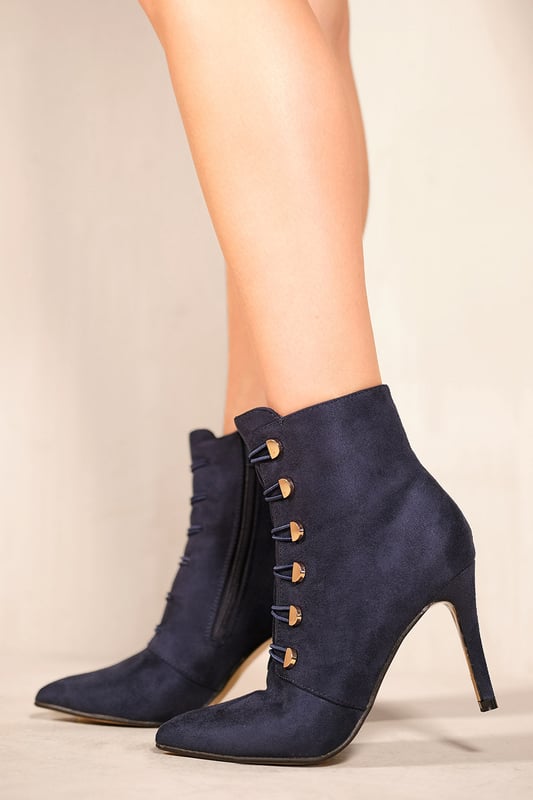 Where's That From Womens 'Blythe' Pointed Toe Mid Heel Ankle Boots In Navy Blue Faux Suede A classic style made more interesting by the addition of a gold buttons! This ankle boot features a pointed toe and mid high heel. Great for parties or everyday wear, the Blythe boots are perfect for adding some fun to your wardrobe. Borrow the style of your favorite celebrity and make it to yourself with this multi-purpose ankle boot.