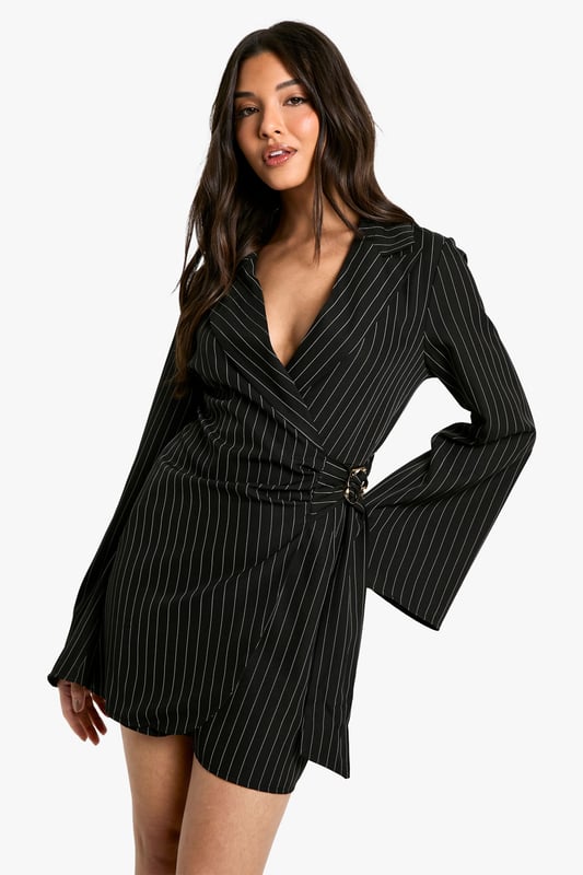 Striking pinstripe pattern for a bold, sophisticated look
        Wrap-style neckline adds a feminine touch
        Unique buckle detail at the waist for added interest
        Flared sleeves create a dramatic silhouette
        Versatile blazer dress design perfect for day-to-night transitions
    
    Make a statement in this eye-catching blazer dress from Boohoo. The pinstripe pattern adds a touch of classic sophistication, while the wrap-style neckline and buckle detail at the waist create a flattering, feminine silhouette. The flared sleeves add drama and movement to the overall look. Perfect for a night out with friends, this versatile piece can be dressed up or down. Pair it with strappy heels and statement earrings for a chic evening ensemble, or layer it over a turtleneck with ankle boots for a stylish daytime outfit. The blazer dress design offers endless styling possibilities, making it a must-have addition to your wardrobe. Whether you're heading to drinks at a trendy bar or dancing the night away at a club, this dress will ensure you stand out from the crowd.