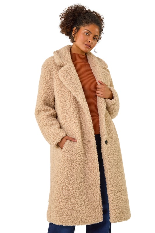 Dusk Borg Detail Longline Coat from Roman. Wrap up in style this Winter with this full-length Borg coat in classic biege. The soft Borg fabric provides ultimate warmth while the button detailing adds a touch of sophistication. Perfect for chilly days, this coat is ideal for layering over your favourite knitwear and jeans for a chic and cosy look that will keep you stylishly warm all season long!