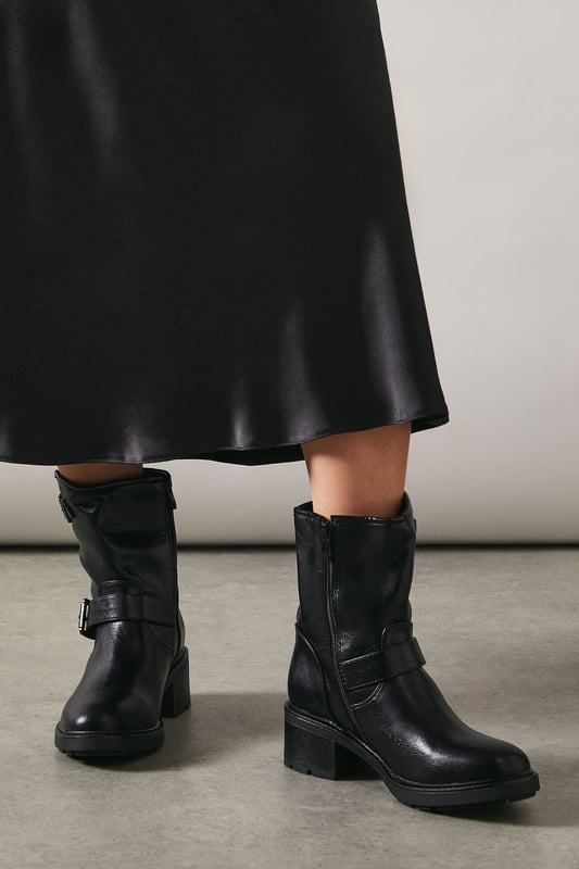 Faux leather ankle boots with edgy biker-inspired design
        Double buckle detailing for adjustable fit and style
        Chunky, durable sole for comfort and traction
        Mid-heel height between 5 and 6.5cm for versatile wear
        Side zip closure for easy on and off
    
    The Janessa Faux Leather Double Buckle Chunky Biker Ankle Boot from Oasis is the perfect blend of style and practicality. These boots project a bold, feminine edge that's ideal for the fashion-forward woman. The mid-heel height offers comfort for all-day wear, making them suitable for both office hours and evening outings. Style them with a flowy midi dress and leather jacket for a chic day-to-night look, or pair with skinny jeans and an oversized jumper for a casual weekend ensemble. The versatile design allows for endless styling options, whether you're aiming for a polished work outfit or a more relaxed, edgy vibe. The chunky sole not only adds to the boot's distinctive look but also provides excellent grip for various terrains, making these boots a reliable choice for unpredictable British weather.