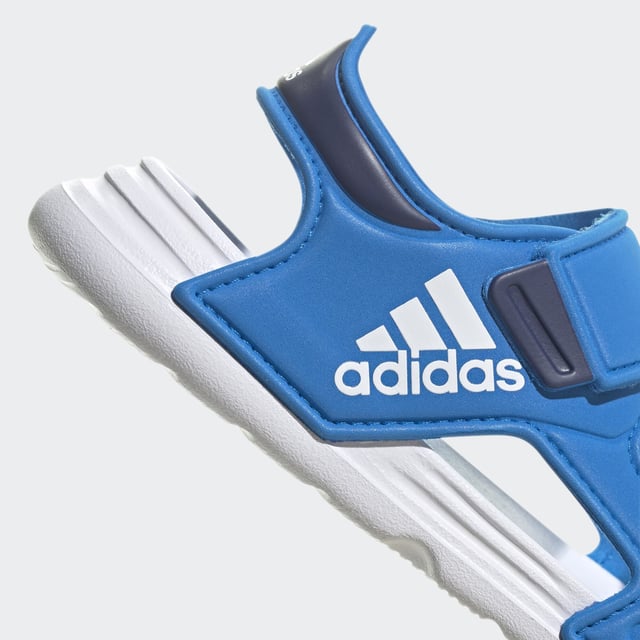 Sunscreen, check. Bucket hat, check. Blow-up unicorn? Maybe later. Let your aquanaut explore the shore in these kids' adidas sandals. Adjustable hook-and-loop straps create a snug fit that adds oomph as they skip stones. A grippy outsole leaves tracks in the sand as the sun sets on their perfect day.  - Regular fit - Hook-and-loop closure - EVA bandage upper - Textile lining - Contoured footbed - Lightweight EVA outsole  Shipped by adidas