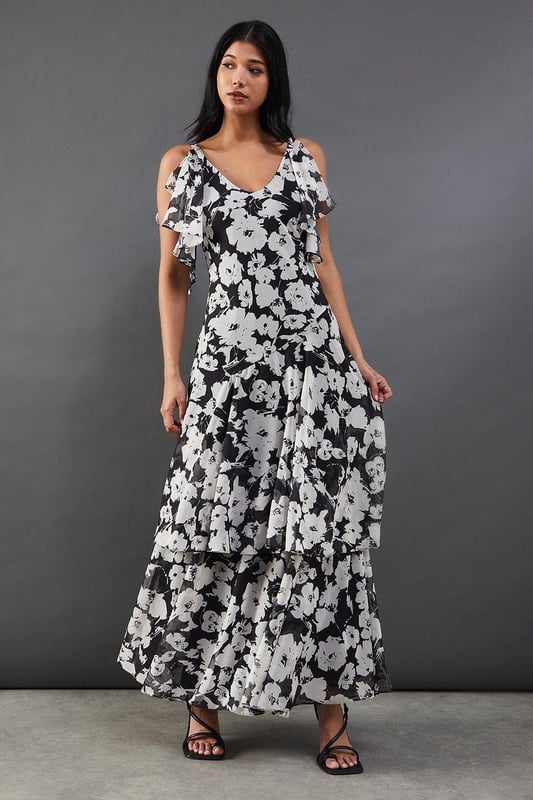 Strappy chiffon midi dress with bold floral print
        Layered tendril design for added movement and dimension
        V-neckline with delicate spaghetti straps
        Cold-shoulder detail with fluttery sleeves
        Tiered skirt with asymmetrical hemline for a dramatic silhouette
    
    Make a statement at your next night out with this captivating floral chiffon midi dress. The striking print and layered tendril design create a mesmerising effect as you move, ensuring all eyes are on you. The strappy neckline and cold-shoulder detail add a touch of allure, while the tiered skirt with its asymmetrical hemline offers a contemporary twist on a classic silhouette. Perfect for cocktail parties or dancing the night away, this dress pairs beautifully with strappy heels and statement earrings. For a more relaxed look, throw on a leather jacket and ankle boots. The versatile design allows for endless styling options, making it a go-to piece for various occasions. Whether you're heading to a rooftop bar or a trendy restaurant, this dress will help you radiate confidence and style.
