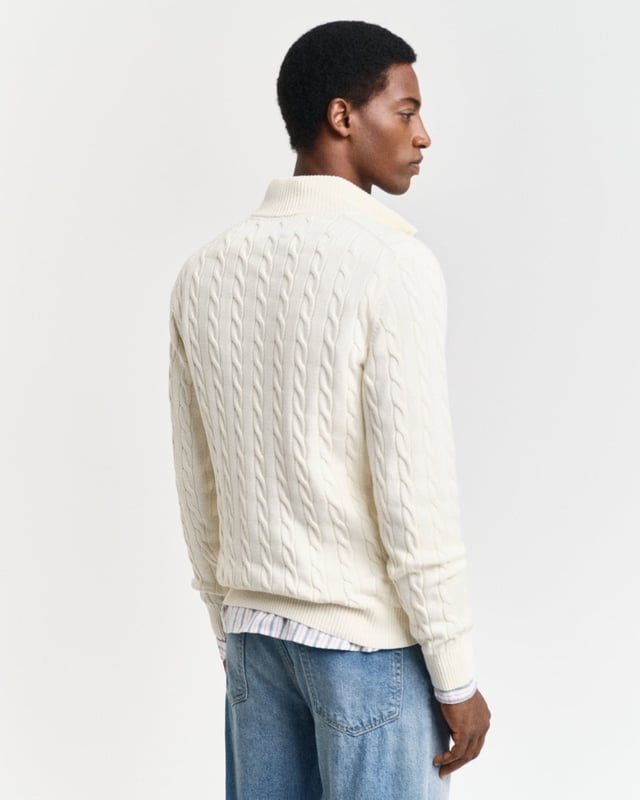 Designed in cotton with an all-over cable knit structure, this soft sweater has a regular fit and sporty half-zip collar. A preppy essential, it is detailed with our iconic GANT shield embroidered at the chest, and ribbed endings at the neck, hem and cuffs.
Regular fitHalf-zip collarCable knit structureGANT graphic embroidered at chest
 
100% Cotton
 