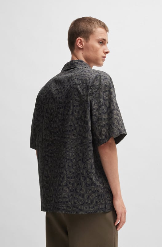 short sleeve shirt - reverse lapels - button closure - poplin - allover print - tag print - animal metal stacked logo - small metal stacked HUGO logo - RESPONSIBLE.A statement shirt in an oversized fit by HUGO Menswear. Designed in breathable cotton poplin  this short-sleeved piece is printed with a seasonal motif.