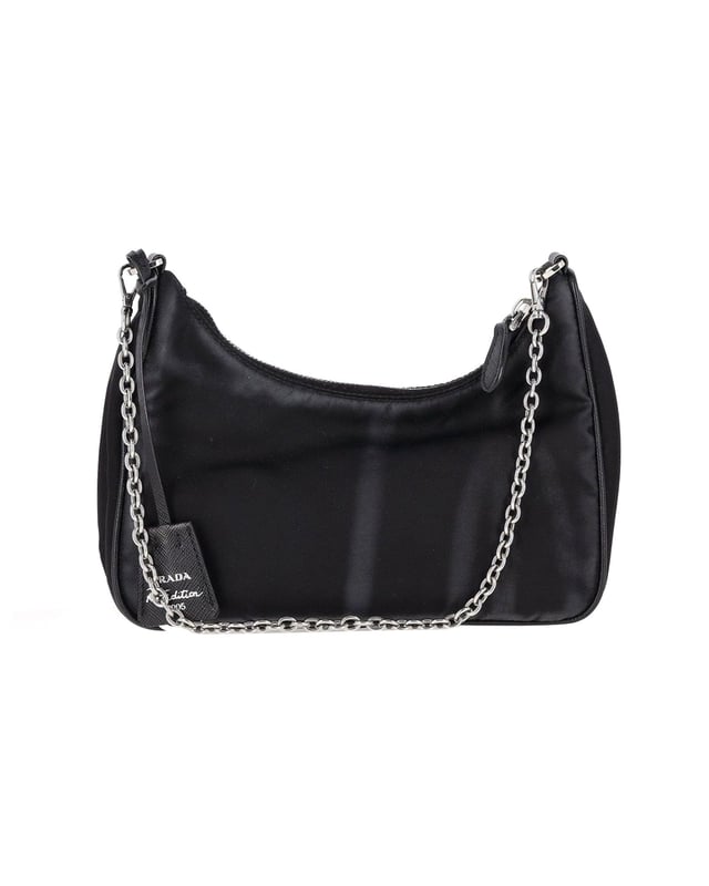 VINTAGE, RRP AS NEW
Elevate your bag collection with the Prada Re-Edition 2005 Re-Nylon Mini Bag. Featuring a timeless mini hobo design, this bag is an iconic piece from Prada. Crafted from Re-Nylon, a material created from recycled plastic trash, it not only makes a stylish statement but also supports sustainable practices. The bag is enhanced with iconic Saffiano leather trims. With a zipper closure for security, an enameled metal triangle logo for a chic brand detail, and a removable chain strap for versatility, this Prada mini bag checks all the boxes of style, functionality, and eco-consciousness.
Prada Re-Edition 2005 Re-Nylon Mini Bag in Black Nylon
Condition: Excellent
Sign of wear: No
Material: Nylon
Color: Black
Dimensions:  
Length: 250 mm
Width: 130 mm
Height: 150 mm
SKU: 358544 / NAPBKGBBA303249W  
Size: One Size