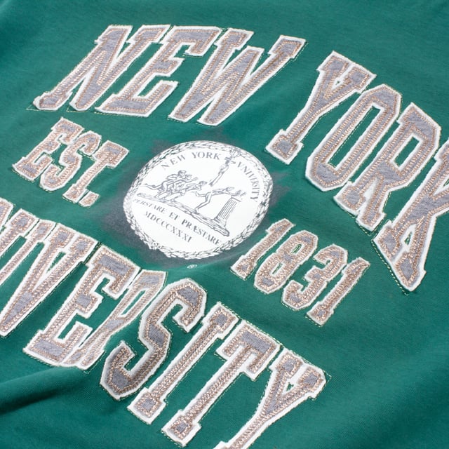 Applique logo tee by Champion, complete with a varsity-inspired design. Crew neck and short sleeves, complete with 'New York University' stitched across the chest &amp; a printed design on the left sleeve.