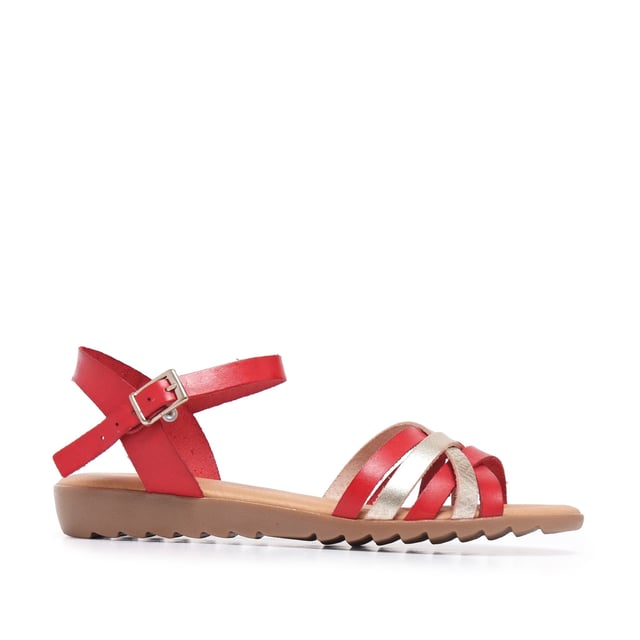 Flat leather sandal with five crossed strips. Closure: metal buckle. Upper, inner an insole : leather. Sole: Non-skid TR caramel color. MADE IN SPAIN.