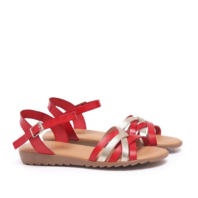 Flat leather sandal with five crossed strips. Closure: metal buckle. Upper, inner an insole : leather. Sole: Non-skid TR caramel color. MADE IN SPAIN.