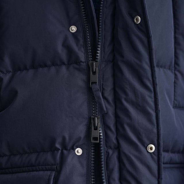 Look no further for the most versatile winter down jacket: the Long Alta Down Jacket. Packed with clever details  this water-repellent jacket made of 90% certified down  10% feathers  has a sleek outer fabric for a goes-with-everything ease. With a detachable hood and ribbed cuffs  this jacket will keep you warm in sub-zero weather without sacrificing style.