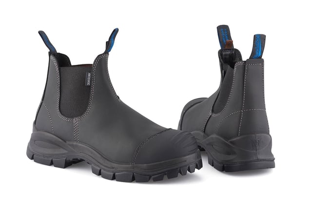 The ultimate workplace boot, these Blundstone 910 safety boots provide all-day support, comfort and protection. Made from premium, durable platinum black leather uppers with a CES3 safety rating, a low shaft with an elasticated side for easy slip-on and a hardened steel toe cap, these Blundstone 910 boots are the ultimate everyday boot. These 910 boots are the result of decades of experience in crafting the highest-quality Australian footwear and whether it be at home, work or anywhere else life takes, these Blundstone boots are a perfect choice.Designed with Blundstones patented shock protection system (SPS) and manufactured with a Thermo urethane outsole and polyurethane midsoles, these 910 boots are built to withstand anything you can throw at it. They also come with a hardened broad fitting steel toe capable cap of resisting a 200 Joule impact with additional kick guard toe protection to ensure your safety is never compromised. However, safety does not come at the expense of comfort with these Blundstone boots; they are made with a steel shank for added support on uneven terrain in addition to a toe spring to help reduce fatigue over long periods of use. Details  Broad fitting steel-toe cap resistant to impacts over 200 Joules Genuine black leather uppers that are oil, acid and organic fat resistant Ergonomically engineered toe spring to help prevent wearer fatigue Full heel breast with arch support to ensure safety on ladders and gantries Highly durable PU midsole and TPU outsole are strongly resistant to hydrolysis and microbial attack Made with Blundstone's patented SPS and XRD™ Technology for increased shock protection Removable Xtreme comfort EVA footbed provides all-day underfoot comfort The V Cut upper reduces stitching exposure and ensures long-lasting durability of these Blundstone boots Outsole resistant to temperatures of up to 140F/60C Low shaft elasticated side for easy slip-on Kickguard toe leather protection Firm supporting steel shank helps with torsional stability on uneven terrains