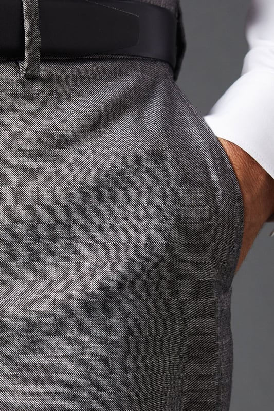 Tailored fit for a refined silhouette
        Sharkskin texture adds subtle sophistication
        Belt loops for versatile styling options
        Side pockets for practicality
        Pressed centre creases for a crisp look
    
    These mid grey sharkskin trousers offer a perfect balance of style and comfort, ideal for the modern gentleman who appreciates classic tailoring. The tailored fit sculpts your silhouette while allowing ease of movement, making them suitable for long days at the office or evening events. Pair them with a crisp white shirt and matching jacket for a complete suit look, or dress them down with a light jumper for smart-casual occasions. The versatile mid-grey hue allows for effortless coordination with various shirt colours and accessories. Whether you're heading to an important business meeting, a wedding, or a sophisticated dinner, these trousers will ensure you look polished and feel confident. Their timeless design makes them a wardrobe staple that will serve you well for years to come.
