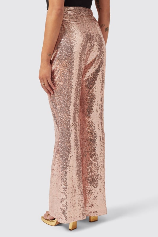 The Caladium Trouser in Rose Gold is a go-to party and event favourite. Adorned with shimmering sequins, It's guaranteed to turn heads as soon as you enter the room. Cut to a slim fit with a flared leg, it's the perfect pair of trousers with a rose gold twist. Pair it with the matching Caladium Jacket in Rose Gold to complete the full look.