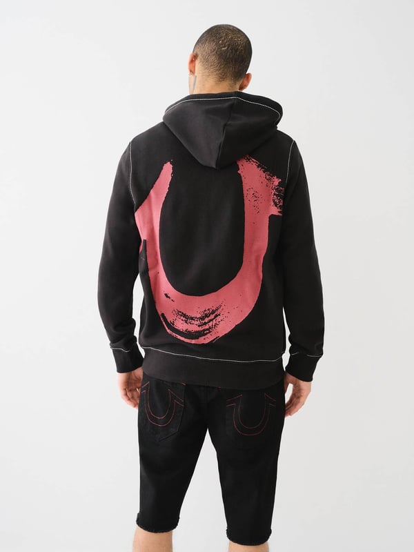 Stay warm in the on-trend Painted Horseshoe Zip Hoodie. This fleece hoodie features a zip-up front, drawstring hood, Big T stitching, long sleeves, and a split kangaroo pocket. Finished with a statement-making painted horseshoe graphic on the back. 