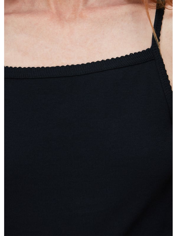 Dress up for comfort with this sleek Scallopped Vest, featuring a soft ribbed material and charming scalloped detailing. A versatile addition to your wardrobe, perfect for layering or as a chic stand-alone piece. Ideal for everyday elegance.