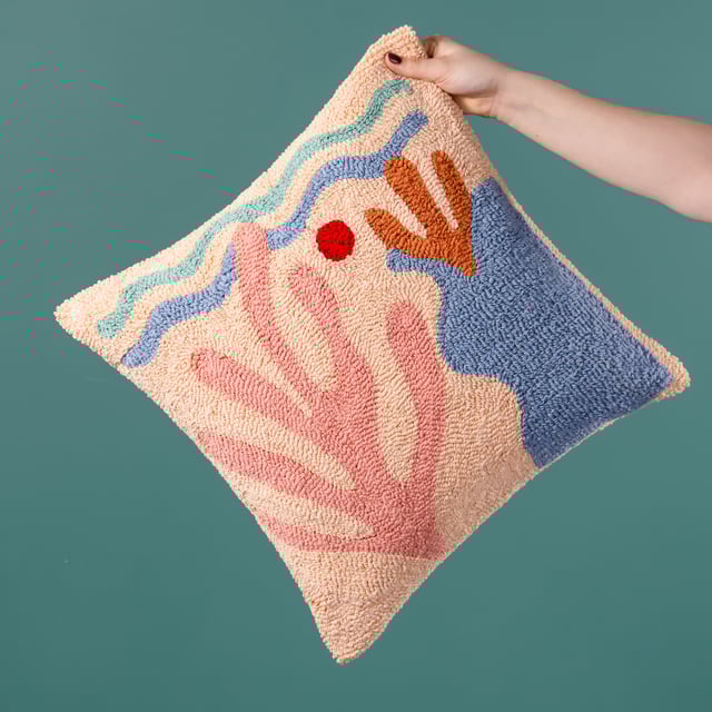 The Corals cushion gives those beach day vibes. It is made up entirely of a unique loop tufted cotton to create a cool abstract design of a sea bed and beach, with large corals growing nearby. Finished with a polycotton canvas reverse, knife edge trim and zip fastening. A fun, friendly and huggable fashion piece to throw on your sofa and help create your own unique living space. Size: 45 x 45cm.
