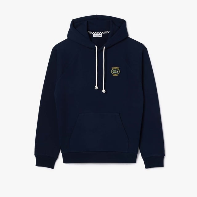 Own the french fashion sport Hoodie in French Terry Raglan sleeves Kagaroo pocket Knot drawcord 55x53 cm felt badge with Lacoste Paris embroidery and green crocodile on chest.