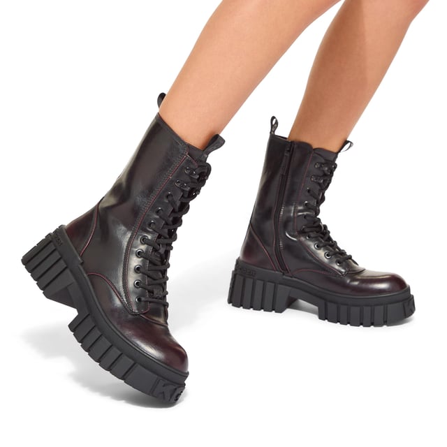 The KG Kurt Geiger Tegan Lace Up boot is a black boot with wine upper which features a KG Kurt Geiger logo printed on ribbed textile with print stitch detailing can be seen at the tongue as well as a black rubber monocle on the tongue.