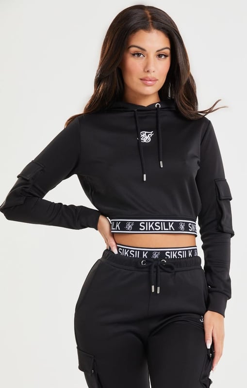 inchBlack Cropped Cargo HoodieSlim crop fitSoft touch fabricBranded jacquard elastic tapeEmbroidered logoCargo pockets on sleevesDrawcord hoodMachine wash95% Polyester 5% ElastaneModel 5ft 10in and wears a size Small inch