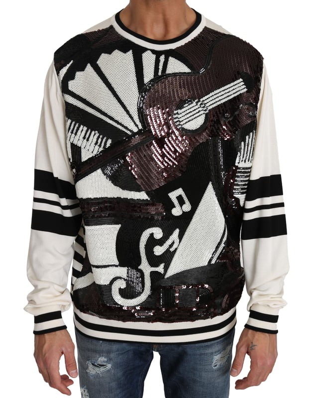 Varumärke: Dolce \u0026 Gabbana\n  Pullover-stil\n  Rund halsringning\n  Färg: Vit och svart med flerfärgade paljetter\n  Kollektion: New York Jazz Guitar\n  Logotypdetaljer\n  Tillverkad i Italien\n  Material: 68% silke 27% polyester 5% nylon\nMaterial: 68% silke 27% polyester 5% nylon