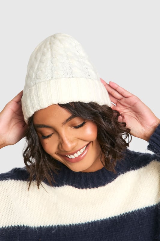 Ribbed texture for added warmth and style
        Cable knit pattern for a classic, timeless look
        Snug fit to keep ears protected from the cold
        Versatile design suitable for various casual outfits
        Soft and stretchy material for comfort
    
    Embrace the chilly weather with this charming ribbed cable knit beanie. Perfect for those crisp autumn days or frosty winter mornings, this hat offers both style and practicality. The intricate cable knit pattern adds a touch of traditional charm, while the ribbed texture ensures a snug fit that keeps you cosy. Pair it with your favourite jumper and jeans for a laid-back weekend look, or throw it on with a casual coat for impromptu coffee runs. Its versatility makes it an ideal accessory for family gatherings, outdoor markets, or casual meetups with friends. The beanie's design allows for easy styling with various hairstyles, whether you're sporting loose waves or a messy bun. Add this essential piece to your wardrobe and stay fashionably warm throughout the cooler seasons.