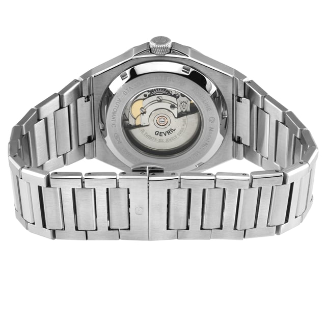 Like a moment of solitude amongst the chaos, Gevril’s High Line Collection is an automatic timepiece with historical roots and sound modern design. Named after Manhattan’s historical High Line park – a nearly 1.5 mile elevated sanctuary of greenery built on a historic steel railway – this collection inspires the cool, calm and collected feel of a walk in the park.   With clean lines and an expert use of space, the High Line collection features Swiss automatic movement encased by 43mm of pure stainless steel. The unencumbered watch face in Forest Green, Navy, Black, Brown or Silver implies that simplicity well constructed is not to be underestimated. The sunray dial, an ode to the outdoor greenway, and a dark colored bezel reminiscent of the original West Side railway add solid touches to structural integrity. Numbers 6 and 12 on the dial denote the middle and end of the path while the date viewing window at 3 evokes memories of overlooking 10th Avenue.   A modern take with historical references, this collection is elevated and understated – if relaxed and sharp were a watch, the High Line would be it. Because architecture doesn’t have to be complicated to be monumental: the High Line collection. 
Gevril 48401B Men's High Line Swiss Automatic Watch
Gevril Men's Automatic Watch from the High Line Collection
43mm Round 316L Stainless Steel Case, Blue Bezel, Blue Sunray Dial
Push/Pull Crown, Date at 6:00
Exhibition Case back
316L Stainless Steel Bracelet with Deployment Buckle
Anti-reflective Sapphire Crystal
Water Resistant to 100 Meters/10ATM
Swiss Automatic, SW200 Movement