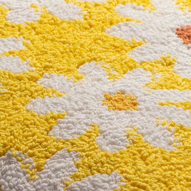 Add some fun flower power to your home with this amazing loop tufted cotton Daisy cushion. Featuring cute white daisies with different coloured centres and set on a vibrant yellow background, this bold design creates a fun, friendly and retro fashion piece. Finished with a plain polycotton canvas reverse, knife edged trim and zip fastening. A great way to create your own style in a new living space.  Size: 45 x 45cm