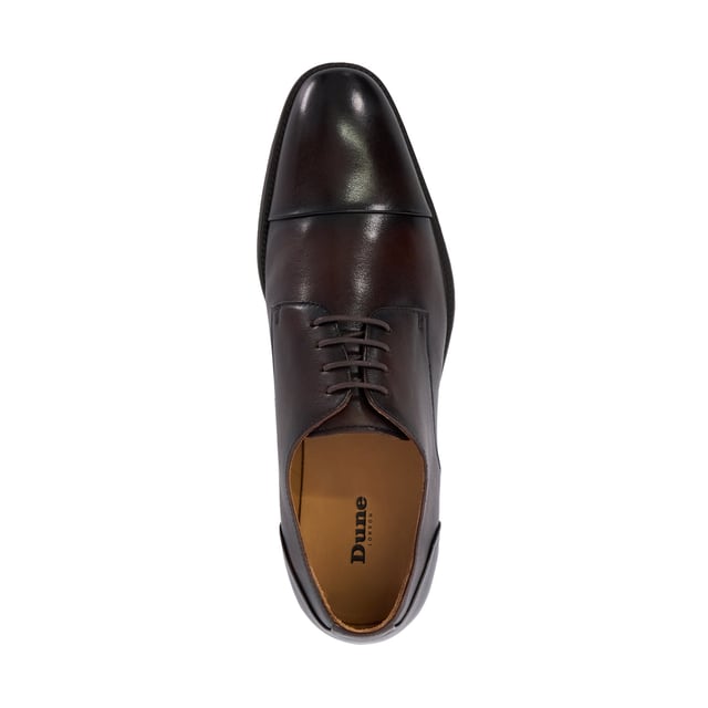 Dune Mens Suffix - Leather Toe Cap Lace Up Derby Important date in the diary? Our timeless lace-up Derby has been designed for those who need to maintain a polished appearance without compromising on comfort. Crafted from smooth, burnished premium leather and boasting a low-block heel and toe cap, this versatile design is guaranteed to enhance every smart outfit. Thanks to the soft cushioning and ergonomic design that supports your feet all-day- long, this hybrid profile will allow you to transition seamlessly from meetings to social events. The flexibility in the sole allows for natural foot movement, reducing strain during long hours of we