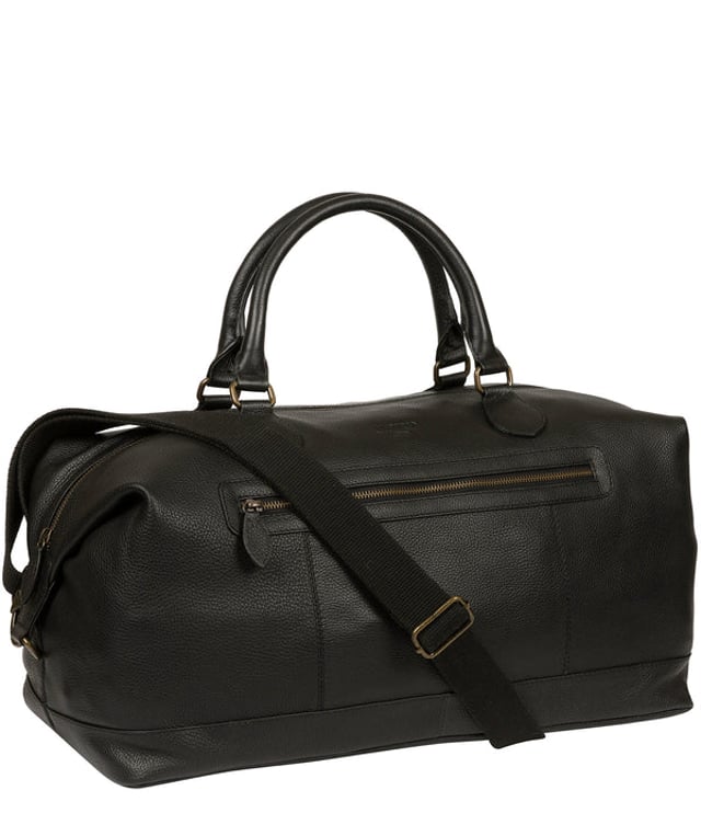 The 'Harbour' holdall from Cultured London is handmade from genuine leather that has a rich texture for a distinct finish and the zip-over top conceals the spacious interior, lined with robust and untreated 100% cotton. A zipped pocket adorns the front of the holdall which is ideal for on-the-go storage and comes with matching leather handles alongside the adjustable and detachable webbed strap, with a drop length of 80cm. Finished with the clean and minimalist embossed Cultured London logo.