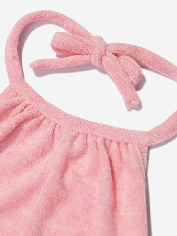 Comfort and style converge for this girls pink playsuit from AY by Ayla. Designed for young influencers, this cosy fleece piece is made for dreaming big with a fashionable twist. Perfect for playdates as well luxe lounging, the soft, lush fabric ensures that feel good factor. Halterneck Tie Fastening Bound Trims