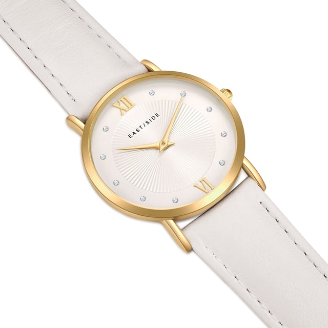 GENERAL INFORMATION:  • Targetgroup: Female  • Wristwatch: No Special Functions  • Display: analogue  • Weight of watch w/o box (gr.) - approx.: 27,0  MOVEMENT:  • Movement: Quartz  • Term of Movement: 2025  • Origin of movement: Japan  BRACELET:  • Material of bracelet/strap: Genuine leather  • Plating of bracelet/strap: None  • Finishing of bracelet/strap: Smooth  • Finishing/Decoration of bracelet/strap: Seam  • Clasp/Closure/Buckle: Buckle  • Color of bracelet/strap: White  • Length of bracelet/strap (mm) approx.: 210,0  • Width of bracelet/strap (mm) approx.: 18,0  • Style/Design of bracelet/strap: No imprint  • Bracelet/strap adjustable?: No  CASE:  • Shape of case: Round  • Size/Diameter of case in mm . approx.: 33,0  • Height of case in mm: 6,7  • Case material: Metal (Alloy)  • Surface of case: Polished  • Bezel/Topring: Fixed  • Finishing/Decoration of case: None  • Material of case back: Stainless steel  • Lock of case back: No screwed-in crown  • Color of case: Yellowgold  • Coating/Plating (Case): Ion-Plating (IP)  • Type/Form of crystal: Flat  • Material of crystal: Mineral crystal  • Water resistant (ATM): 3  DIAL:  • Size jewelry care cloth: Hour, Minute  • Indices: Roman numerals/points  • Material of dial: Brass  • Structure/pattern of dial: sunray  • Color of dial: White  PUSHER, CROWN, HAND:  • Pusher: None  • Corrector: No  • Crown: No screwed-in crown  • Type of hands: Dauphine hands  • Luminescent (hands): No  PACKAGING & SCOPE OF DELIVERY:  • Box: Yes  • Service booklet: Yes  • Manual: Yes