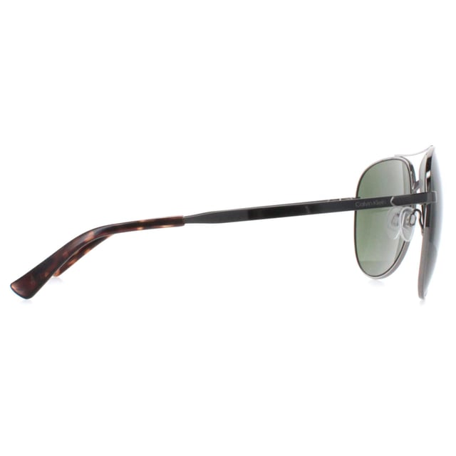 Calvin Klein Aviator Mens Light Ruthenium Green CK22124S  Sunglasses are a harmonious blend of contemporary design and timeless sophistication. Crafted with precision and elegance, these sunglasses feature a sleek and minimalist frame that embodies understated luxury. They boast a lightweight construction for all-day comfort, while its lenses offer superior sun protection and reduce glare, ensuring optimal clarity and vision.