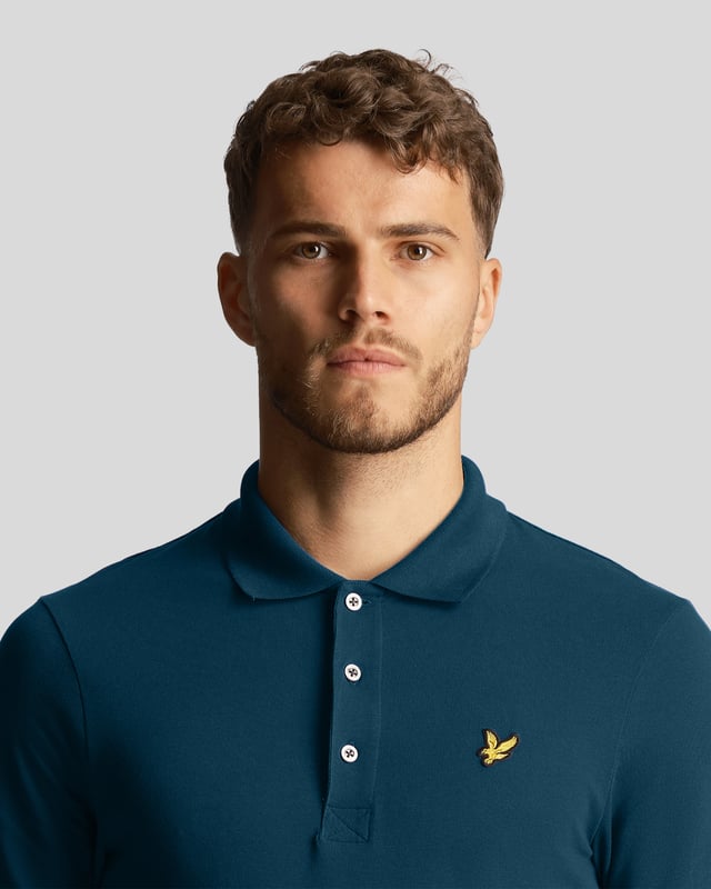The Lyle &amp; Scott plain polo shirt is part of our Essentials range. Made from 97% cotton, it is a classic polo for a reason, made with a regular fit, cuffed sleeves &amp; three-button collar.