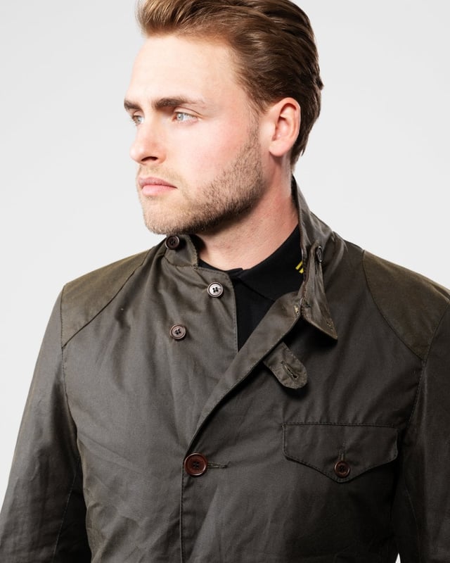 Barbour Beacon Sports Wax Jacket
As this is a slim fitting jacket, we would advise purchasing the next size up than you would normally choose. The three-pocket waxed Beacon Sports jacket is an iconic blazer-style button through, inspired by the sought-after, limited edition To Ki To Sports Jacket. Effortlessly stylish and easy to wear, the Beacon Sports Jacket is a mediumweight waxed cotton jacket featuring soft leather-bound cuff edges, shoulder and elbow patches, two zipped rear pockets and a button-up throat flap. Lined with Barbour tartan, this jacket reflects traditional Barbour elements, with classic hip-height bellows pockets and a single chest pocket. This jacket is surprisingly versatile, and looks great worn as a blazer with the collar folded down and lapels open, or with the collar turned up worn over a fine-knit jumper and scarf for a contemporary country look.

Tailored Fit
Barbour tonal embroidery to left pocket
Outer: 100% cotton (waxed)
Lining: 100% cotton
Trim: 100% wool
6oz waxed cotton
Do not wash
Sponge clean only
Back length: 69cm - 81.5cm

MWX0007