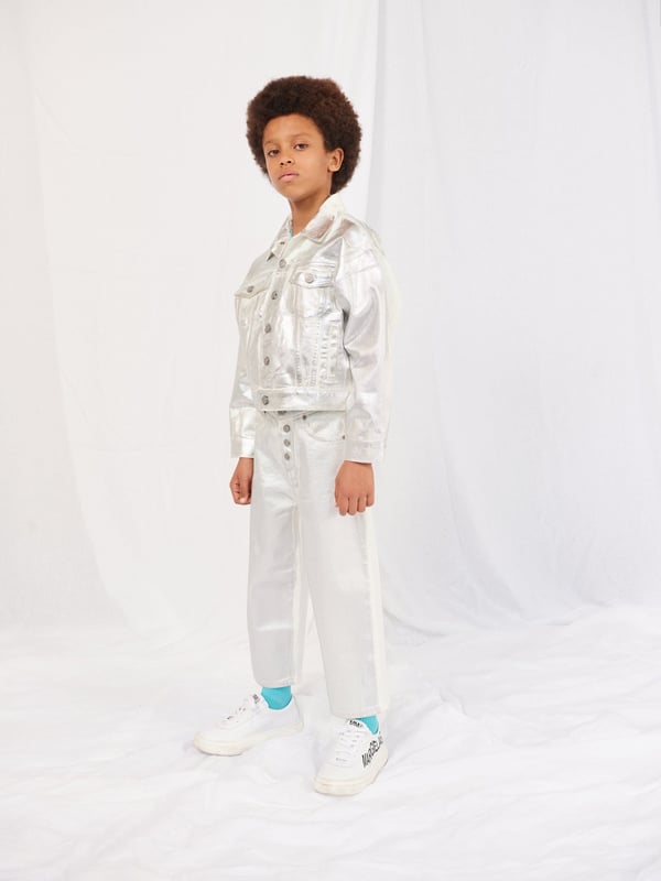 Introducing the Kids Metallic Effect Jeans in Silver from mm6_maison_margiela, a high-end designer piece for your Boy or Girl. Enhance their style quotient with these key features: Bold and shiny: These metallic effect jeans are sure to grab attention with their bold and shiny look. They're the ultimate statement in kids' fashion.  Comfortable Fit: Crafted from high-quality materials that conform to the body comfortably, these jeans are perfect for all-day wear. Unisex Design: Suitable for both Boys and Girls, these unique jeans fits seamlessly into any junior wardrobe.Revamp your child's fashion game with these lavish Kids Metallic Effect Jeans in Silver. Let them shine bright with mm6_maison_margiela! Order today.
