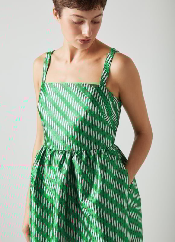 A dress that says 'belle of the ball', Elodie is a beautiful reimagition of our hero Olsen skirt, but in dress form. Crafted from voluminous, bouncy fabric with a green, black, white and metallic geometric weave, Elodie has a square neckline, slim shoulder straps, a gathered waist, side pockets and a puffy shape falling to just below the knee. Wear with green satin platforms to perfectly match, or style more casually with simple ballet flats - she's versatile, and very good fun.