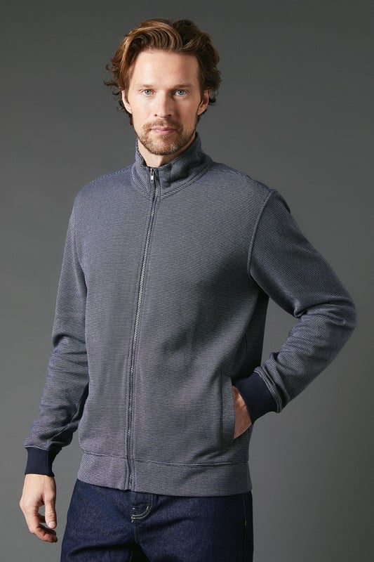 Birdseye textured fabric for a subtle, sophisticated look
        Full-length zip closure for versatile styling options
        Stand-up collar adds a refined touch
        Ribbed cuffs and hem for a snug fit
        Side pockets for practicality and hand warmth
    
    The Maine Birdseye Zip Through Sweat seamlessly blends comfort with style, making it a versatile addition to any casual wardrobe. The textured birdseye fabric adds depth and interest to this otherwise classic design, setting it apart from standard sweatshirts. Perfect for those laid-back weekend outings or casual Friday at the office, this sweat can be easily dressed up or down. Pair it with dark wash jeans and white trainers for a smart-casual look, or layer it over a crisp shirt for a more polished ensemble. The full-length zip allows for adaptable styling, whether fully zipped for a sleek silhouette or left open for a more relaxed vibe. Ideal for British weather, this sweat is your go-to for those unpredictable days when you need an extra layer without compromising on style. From family gatherings to casual meetups with friends, this Maine sweat ensures you're always comfortably stylish.