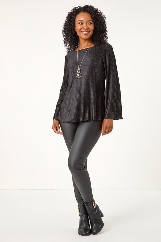 Petite Pleated Necklace Top from Roman. Add a touch of glamour to your Winter wardrobe with this statement petite top. Crafted from a pleated woven fabric, this round neck top features chic long sleeves and a flattering hip-length finish. The standout feature is the attached necklace trim, adding a touch of sparkle and eliminating the need for extra accessories. Easy to wear and effortlessly stylish, pair this top with tailored trousers and heels for a sophisticated look that transitions seamlessly from day to night!