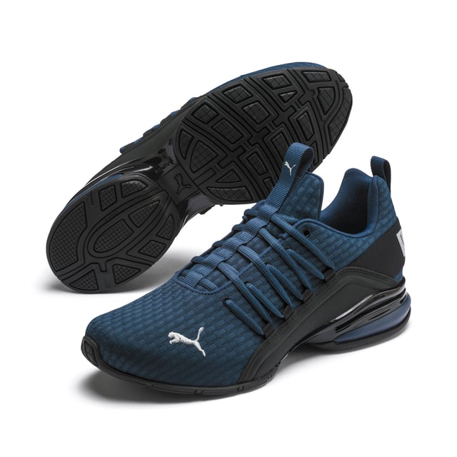 PRODUCT STORY Be bold in the game-changing silhouette of our Axelion Block Running Shoes, which combine contemporary design with the supreme comfort of our foam heel unit for the last word in athletic style. DETAILS   Low boot   Textile upper   Foam heel   TPU shank   Rubber outsole   PUMA Cat Logo at toe