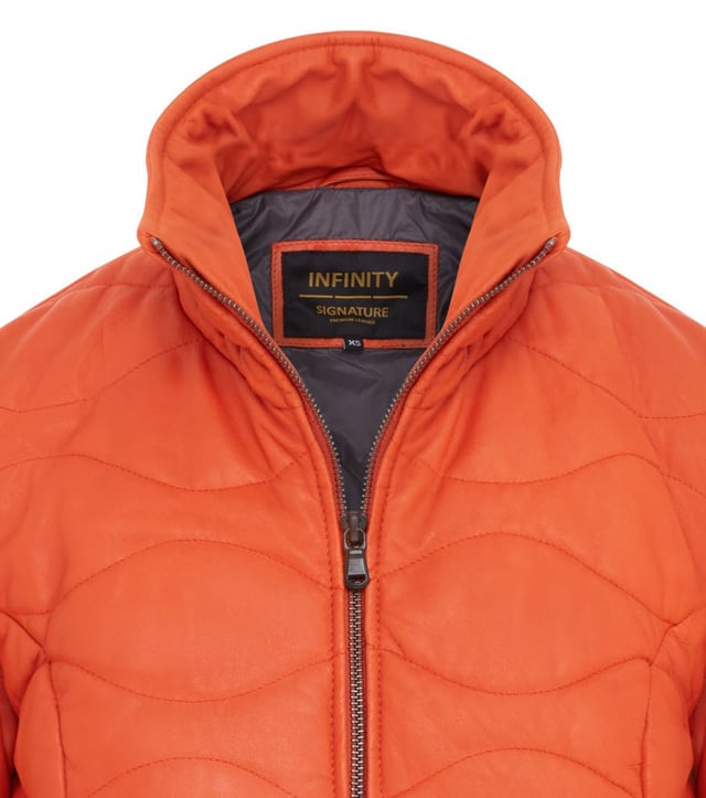 Experience the perfect blend of sophistication and practicality with our Infinity Signature Range Women's Leather Puffer Jacket. Crafted from premium sheep nappa leather, this jacket features innovative insulated quilting and staggered horizontal dash quilt lines for superior warmth and timeless style. Designed with functionality in mind, it boasts an exposed UMZ zip, stand up collar, for added comfort. Zipped handwarmer pockets provide warmth, while the fully cotton-lined interior with two vertical zipped pockets and a phone pocket ensures convenience. This jacket redefines elegance and durability, making it an essential addition to your wardrobe.

Key Features:

Premium sheep nappa leather for luxurious softness.
Insulated quilting for enhanced warmth and style.
Exposed UMZ zip and clever collar zip for unique detailing.
Elastic-trimmed cuffs for added comfort and protection.
Two zipped handwarmer pockets and two inner pockets.
Fully nylon-lined interior with two zipped pockets and a phone pocket.
Timeless design perfect for versatile styling.