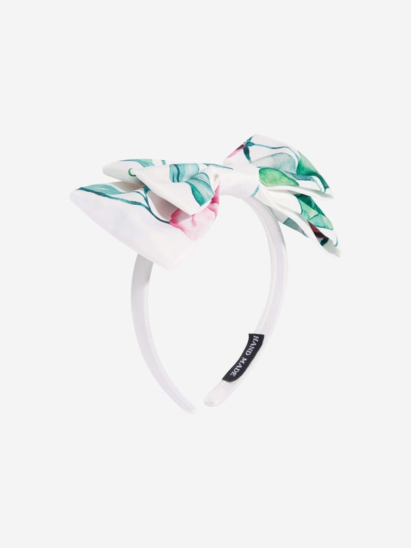 Californian label Mama Luma depict beautiful designs via their ethically sourced fabrics. This girls green white headband is reflective of the label's fine detailing and handmade construction. Envisioned with a green and pink leaves pattern, an enlarged bow and plastic inner structure. She will look and feel divine.  ‚ Handmade