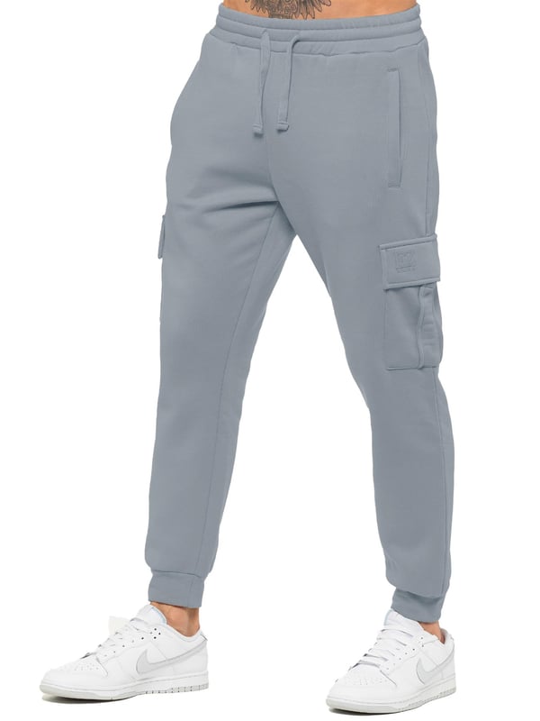 Experience superior comfort and style with Enzo Men's Regular Fit Cargo Joggers! Crafted with a brushed back inner fleece lining, these joggers are designed to keep you cozy all day long. Perfect for casual wear, they feature convenient 2 side slash pockets and 2 cargo pockets, providing ample storage space for your essentials. Stay on-trend with the cuffed leg design, offering a modern silhouette and added comfort.