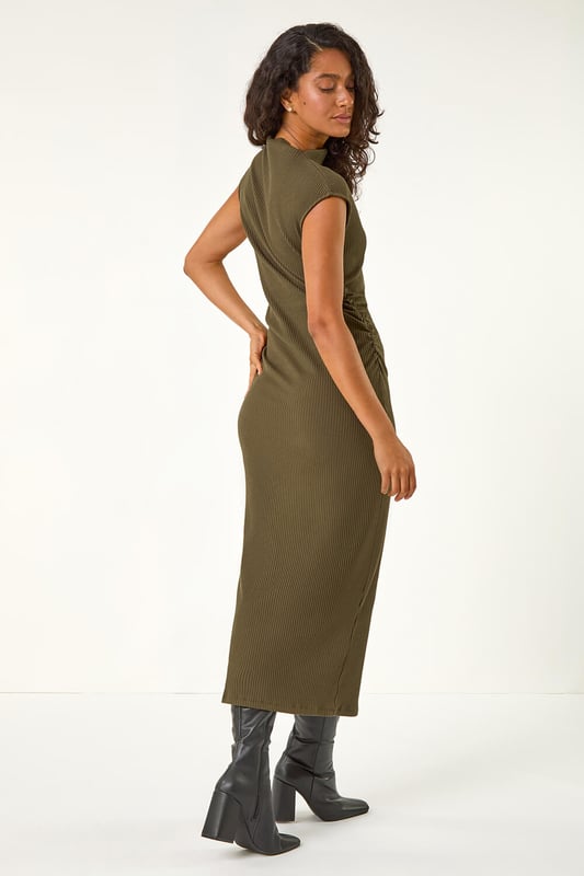 Dusk Ribbed Ruched Waist Midi Dress from Roman. Get ready to stun this Autumn Winter season in our ribbed midi dress. The high neckline gives a classic touch, while the soft cotton blend fabric and sleeveless design provide comfort and style. The ruched waist adds a flattering detail to this bodycon silhouette, all falling to a midi length. An easy pull-on style makes this a must-have dress for your wardrobe. Pair with winter boots, tights, and a coat for a cosy fall look!