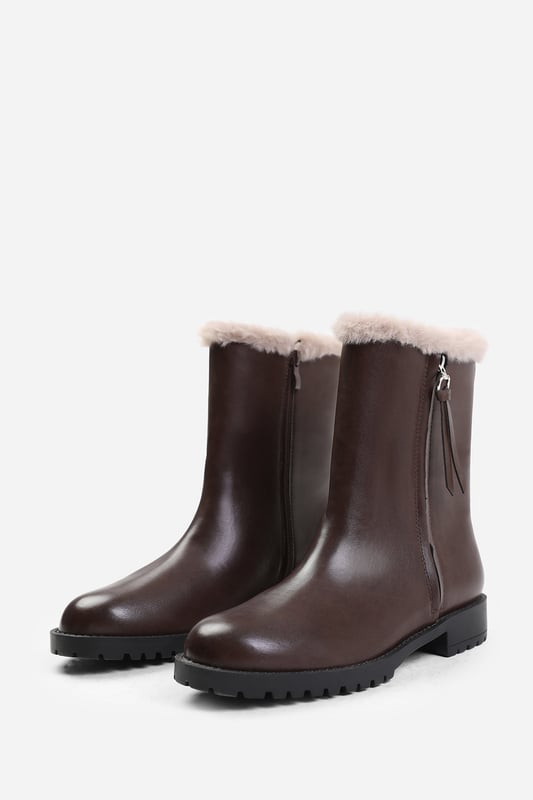 Make a bold fashion statement with our Ice Wide Fit Mid Calf Boots With Fur Trim. These boots combine style and functionality, offering a unique and trendy addition to your shoe collection.Key Features:



Chunky Design: These boots adds a touch of edginess and flair to your outfit. The chunky sole and heel provide stability and support while giving you a confident and fashion-forward look.

Side Zip: The side zip closure makes these boots easy to put on and take off. The side zip adds convenience. This also adds a stylish and modern touch to the overall design.


Specifications:


Material: Faux Leather
Heel Height: 2.3' (5.8cm) approx
Boot Height: Mid-calf
Closure: Side zip closure for easy wear


Step up your fashion game with our Ice Wide Fit Mid Calf Boots With Fur Trim. These boots offer a combination of style, comfort, and versatility, ensuring you make a lasting impression wherever you go. Embrace the chunky heel trend with these trendy and fashionable boots.