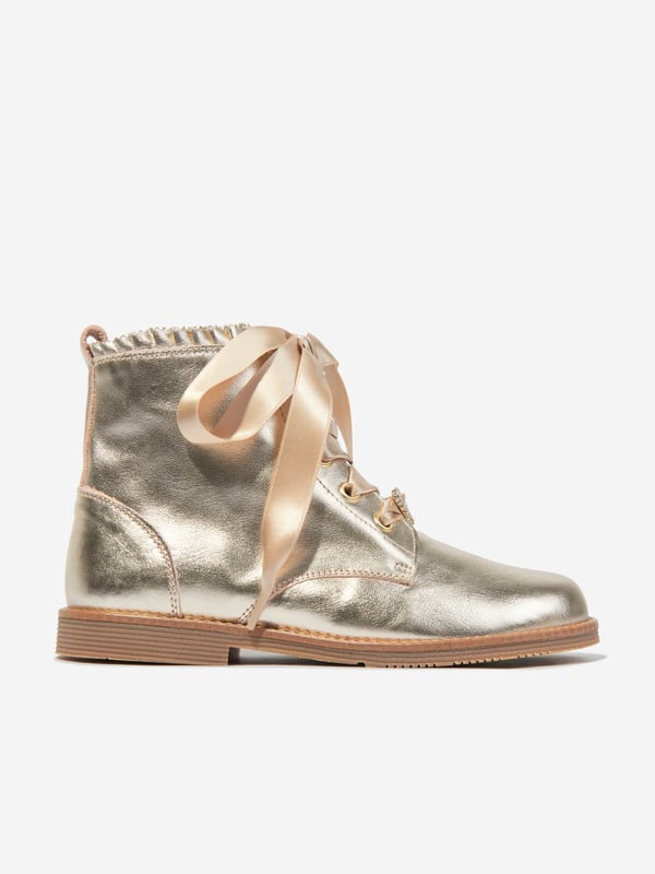 Introducing the exquisite Girls Leather Lace Up Boots in Gold by andanines, a deluxe addition to any young fashionista's AW2024 collection. These exceptional boots blend timeless design with chic modernity, perfect for stylish adventures. Key features include: Luxurious Craftsmanship: Expertly made in Spain with premium leather for a refined look and resilience. Striking Gold colour: A dazzling gold finish that captures the eye and elevates any outfit. Secure Lace-Up Design: Ensures a comfortable, adjustable fit for growing feet. Versatile Style: Ideal for both special occasions and everyday wear, offering endless pairing possibilities.Revamp your girl's wardrobe with these stunning Gold Lace Up Boots from andanines. Witness elegance and style in every step she takes!