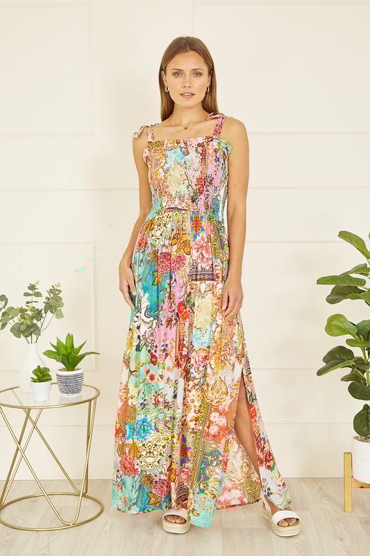 A truly show stopping all over print designed in house for Yumi, inspired by Indian fabrics, with a patchwork feel, This maxi dress will look right at home in the sunshine, with tie straps and a ruched bodice adding a comfortable feel. The maxi length had a flirty side split in the hemline, style with simple sandals and a beach bag.